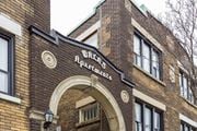 Kitchener apartment for rent - A brick building with a sign that says "Walnut Apartments".