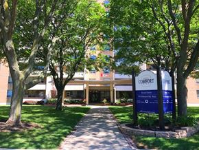Hamilton apartment for rent - A Comfort senior living facility is surrounded by trees.