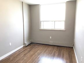 Hamilton apartment for rent - A room with a window and a radiator on the floor.