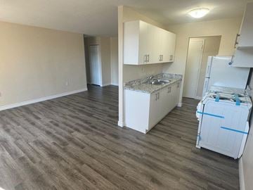 Stoney Creek apartment for rent - A room with a kitchenette and a refrigerator.