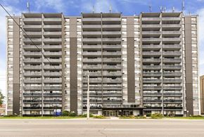 Hamilton apartment for rent - A large, modern apartment building with multiple balconies and a flat roof.