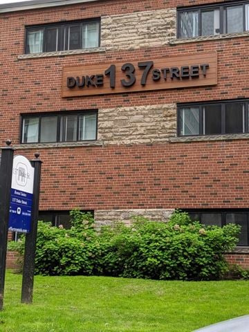Hamilton apartment for rent - A brick building with a sign that says Duke 137 Street.