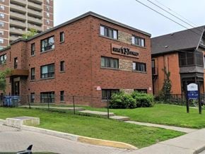 Hamilton apartment for rent - A red brick building with the words "Hillcrest Manor" on the front.