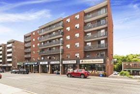 Dundas apartment for rent - A red car is parked in front of a building with a sign that says "Dundas Shawarma.".