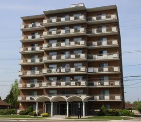 Hamilton apartment for rent - A large apartment building with balconies and a covered entrance.