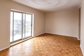 Hamilton apartment for rent - A room with a large window and wooden flooring.