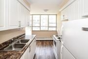 Stoney Creek apartment for rent - A kitchen with white cabinets and a granite countertop.