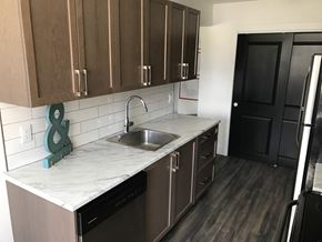 Waterloo apartment for rent - A kitchen with brown cabinets and a marble countertop.