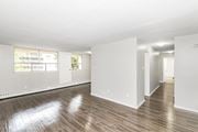 Stoney Creek apartment for rent - A large empty room with wooden floors and white walls.