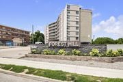 Hamilton apartment for rent - A modern building with the name "FOREST HILL" on it.