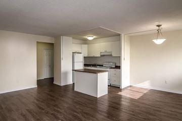 Hamilton apartment for rent - A kitchen with white cabinets and a wooden island.
