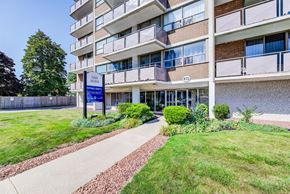 Hamilton apartment for rent - A building with a sign that says "Grace Manor" in front of it.