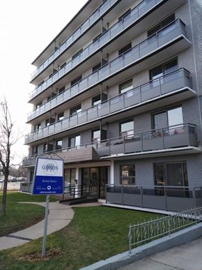 Hamilton apartment for rent - A Gibson apartment building with a blue sign in front.