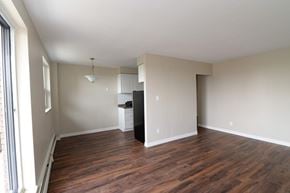 Hamilton apartment for rent - A room with wooden floors and white walls.