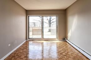 Hamilton apartment for rent - A room with wooden flooring and a sliding glass door leading outside.