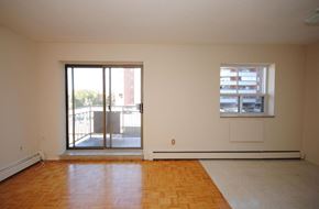 Stoney Creek apartment for rent - A room with a wooden floor and a window with blinds.