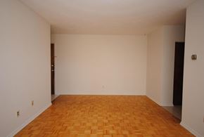 Stoney Creek apartment for rent - Empty room with wooden floor and white walls.
