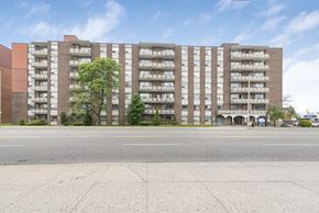 Hamilton apartment for rent - A large brick building with many windows and balconies.