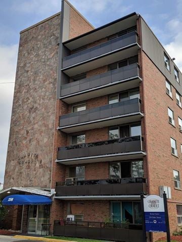 Hamilton apartment for rent - A tall brick building with balconies and awnings.