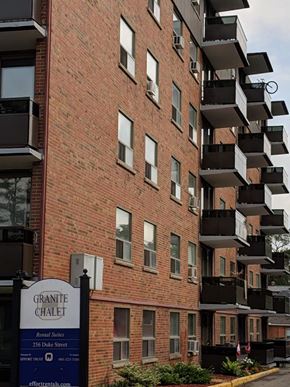 Hamilton apartment for rent - A brick building with balconies and a sign that says Granite Chalet.