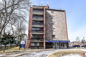 Hamilton apartment for rent - A tall brick building with a blue awning and a sign that reads "FANNY'S".