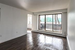 Hamilton apartment for rent - A room with a large window and wooden flooring.
