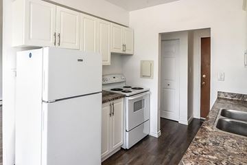 Hamilton apartment for rent - A white refrigerator is in a kitchen with white cabinets.