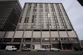 Hamilton apartment for rent - A tall building with a sign that says "William Morris Ltd" on the front.
