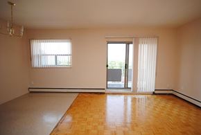 Hamilton apartment for rent - A room with a wooden floor and a sliding glass door.