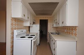 Hamilton apartment for rent - A kitchen with a white stove and cabinets.