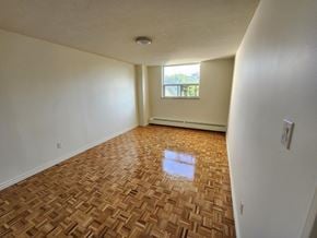 Kitchener apartment for rent - A room with a wooden floor and a window.
