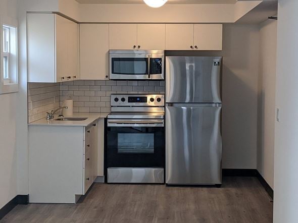 Cambridge apartment for rent - A modern kitchen with a stainless steel refrigerator, oven, and microwave.