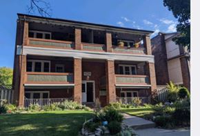 Kitchener apartment for rent - A large, old building with a balcony on the second floor.