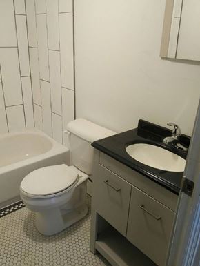 Kitchener apartment for rent - A white toilet sits next to a sink in a bathroom.