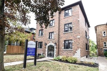 Kitchener apartment for rent - A brick building with a sign that says Brownstone.