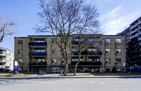Stoney Creek apartment for rent - A large apartment building with a parking lot in front.