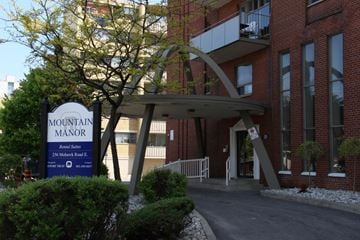 Hamilton apartment for rent - A sign for Mountain Manor is in front of a building.