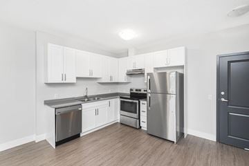 Woodstock apartment for rent - A kitchen with white cabinets and stainless steel appliances.