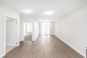 Woodstock apartment for rent - A spacious room with wooden floors and white walls.