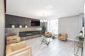 Woodstock apartment for rent - A modern living room with a fireplace and a glass coffee table.