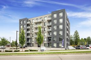 Woodstock apartment for rent - A modern apartment building with balconies and a flag on the front.