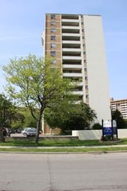 Hamilton apartment for rent - A tall building with a tree in front of it.