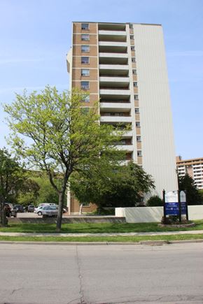 Hamilton apartment for rent - A tall building with a tree in front of it.