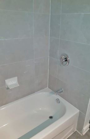 Dundas apartment for rent - A white bathtub with a silver faucet and a silver shower head.