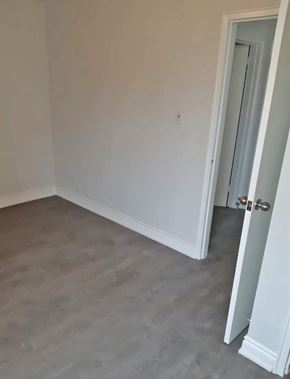 Dundas apartment for rent - A room with a closed door and a grey floor.