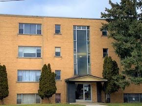 Dundas apartment for rent - A red brick building with a black door and windows.