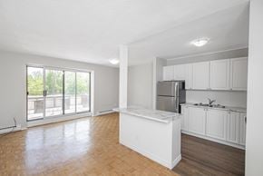 Burlington apartment for rent - A kitchen with white cabinets and a marble island.