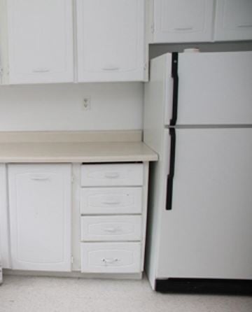 Hamilton apartment for rent - A white fridge in a kitchen with white cupboards.