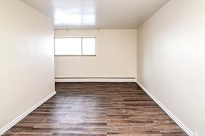 Welland apartment for rent - A room with wooden flooring and a window.