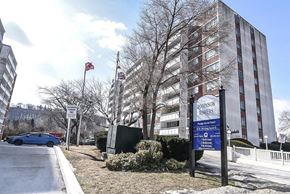 Stoney Creek apartment for rent - A sign for the Robinson Towers stands in front of a large building.